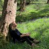 nature connected lady sitting under a tree