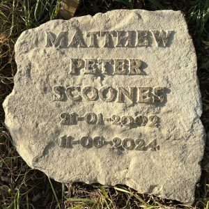 dedication stone engraved with name and dates