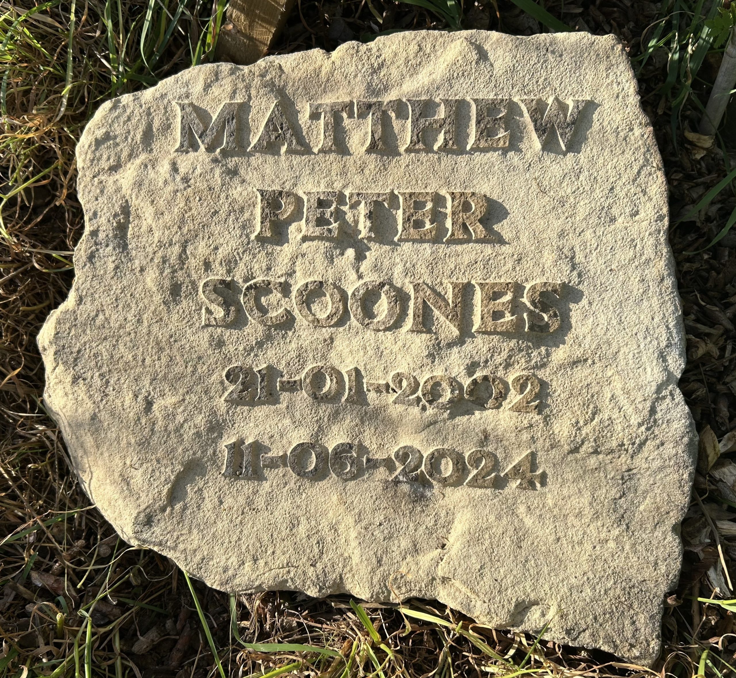 dedication stone engraved with name and dates